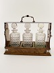 English tantalus with 3 decanters in polished oak box sold