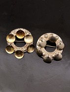 A pair of silver brooches