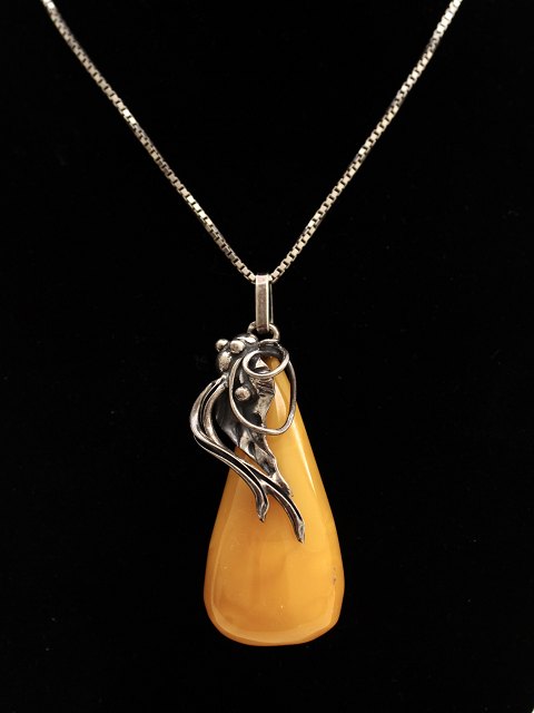 Sterling silver necklace with amber pendant mounted in sterling silver