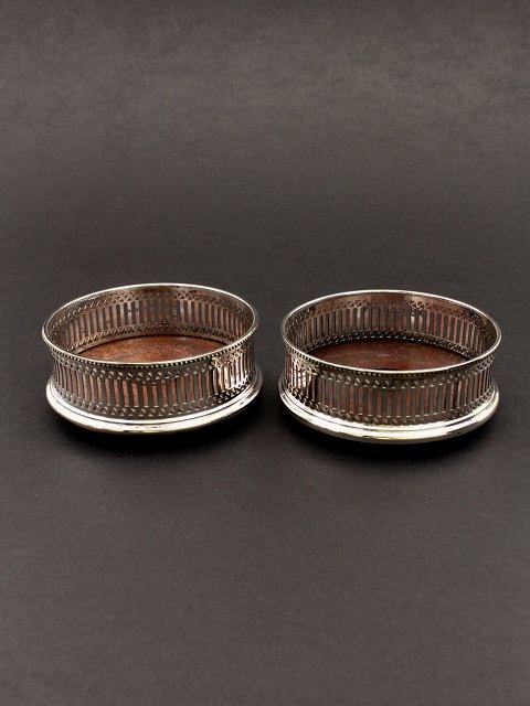 A pair of silver-plated wine coaster