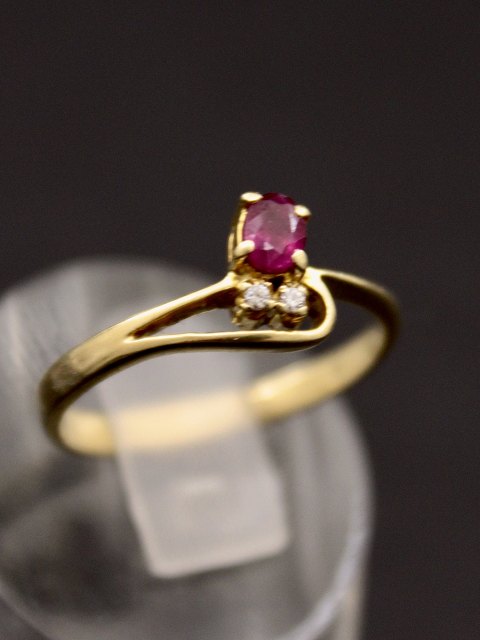 14 carat gold ring with ruby and 2 zircons