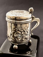 Silver mug with old silver schilling coin